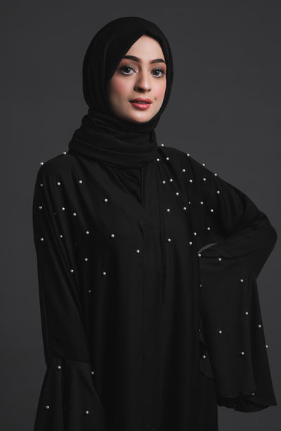 black abaya with white pearls on chest and sleeves