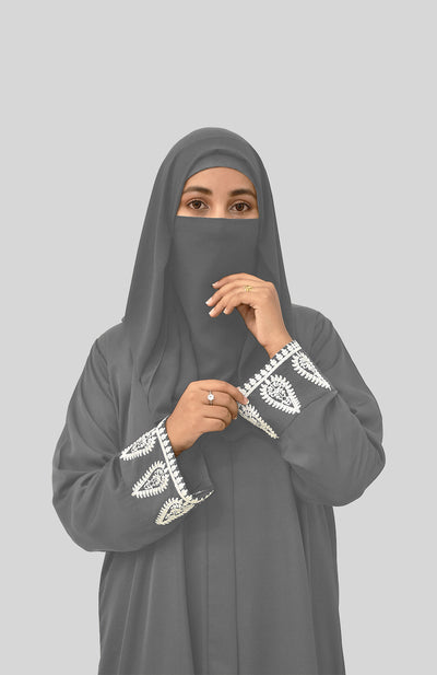 women with grey embroidered abaya and grey niqab