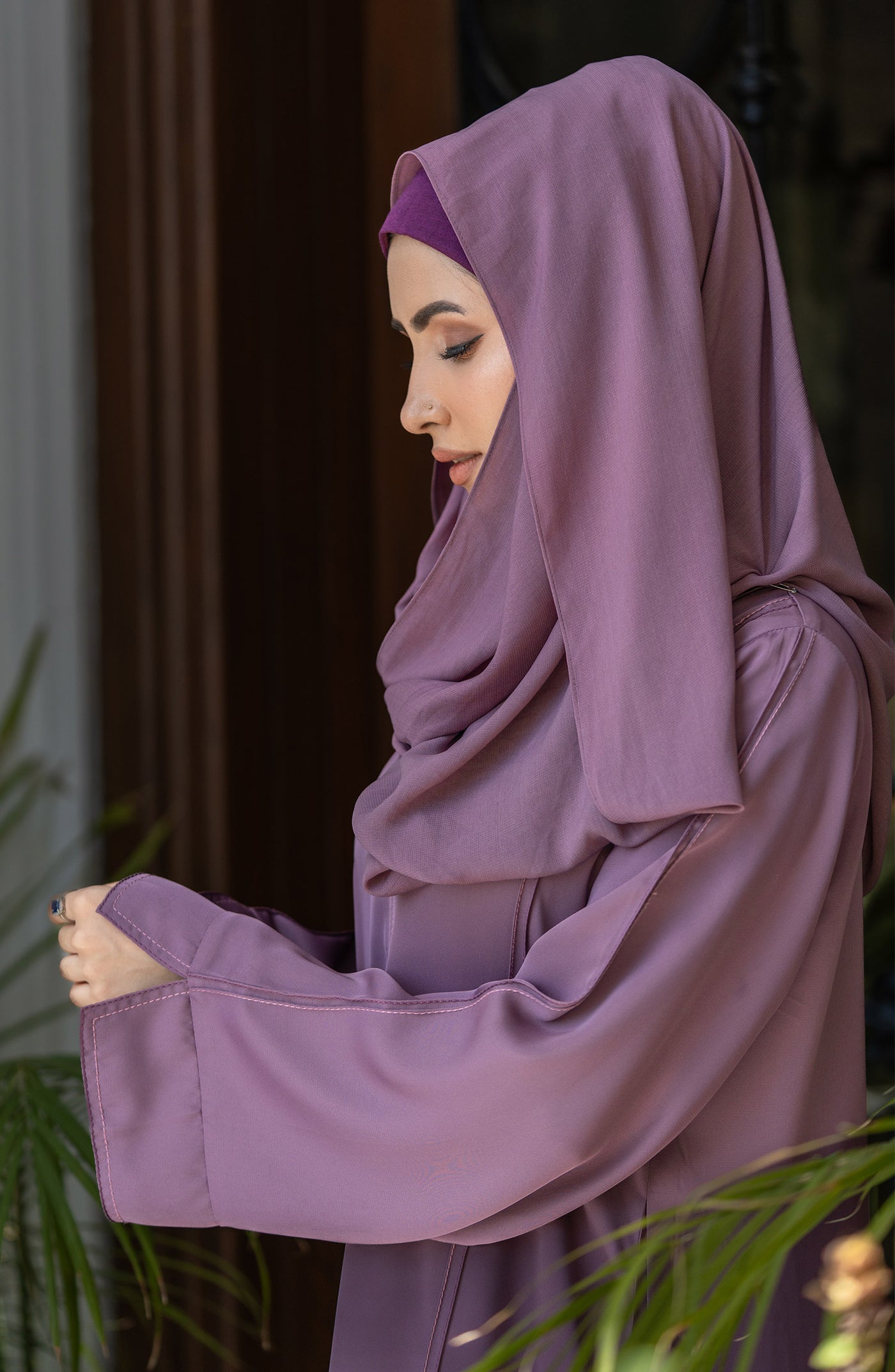 women with rose color abaya and hijab