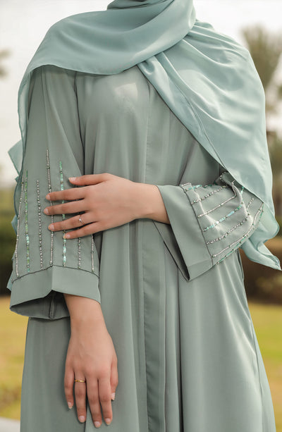 mint open gown maxi with stone and pearls on sleeves
