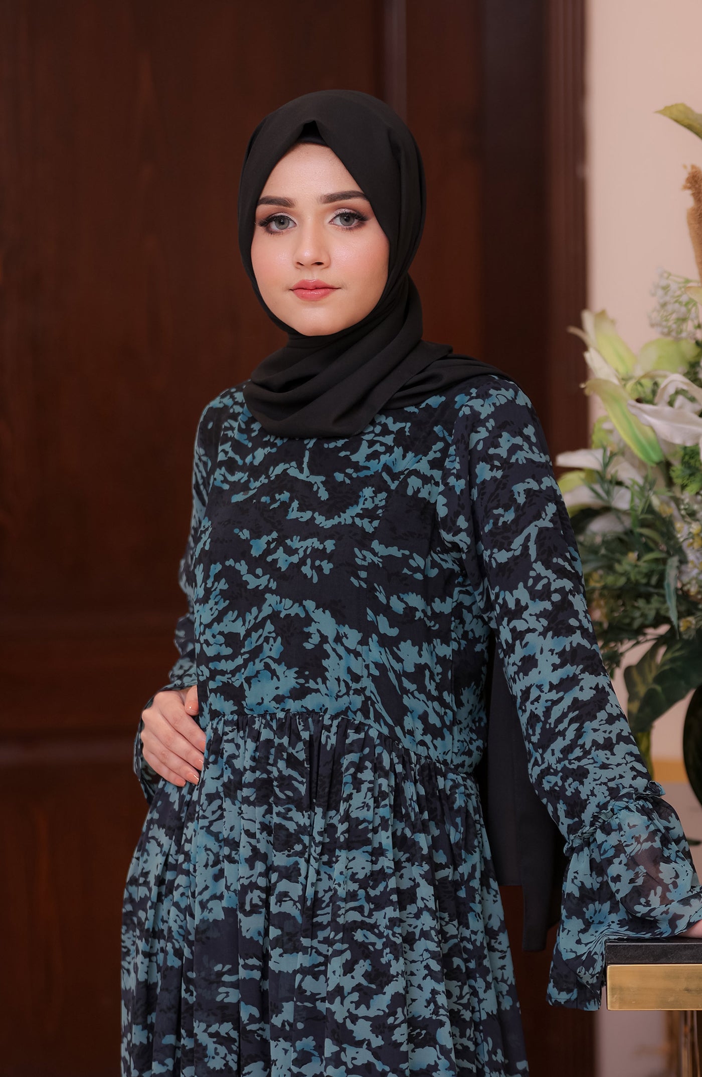 women with long navy blue maxi dress & black hijab