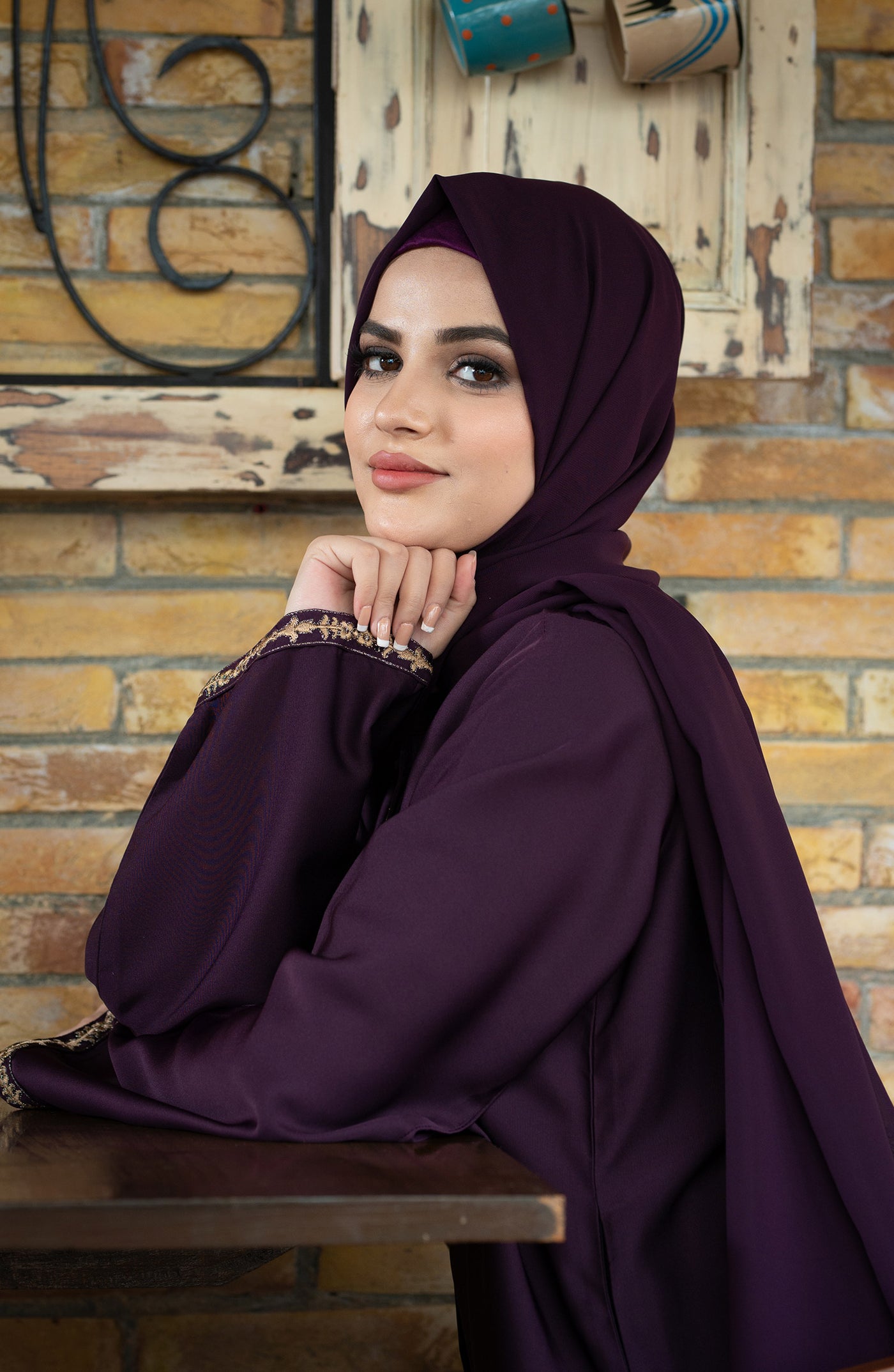women with raisin purple abaya & hijab