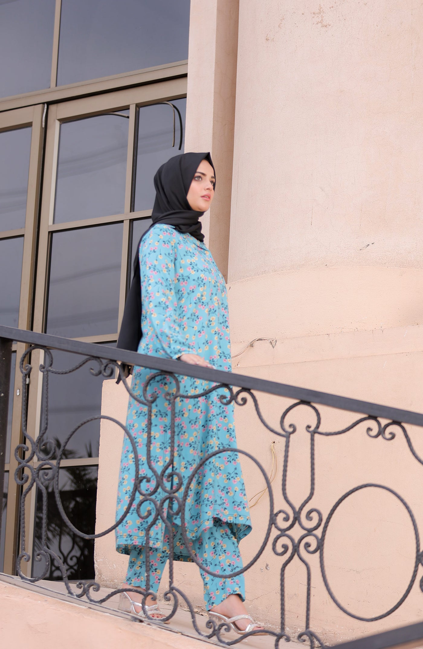 women in long modest ice blue co-ord set with black hijab