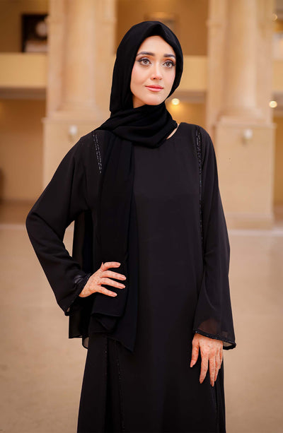  Stylish black abaya in traditional Arabic design, perfect for any formal occasion. 